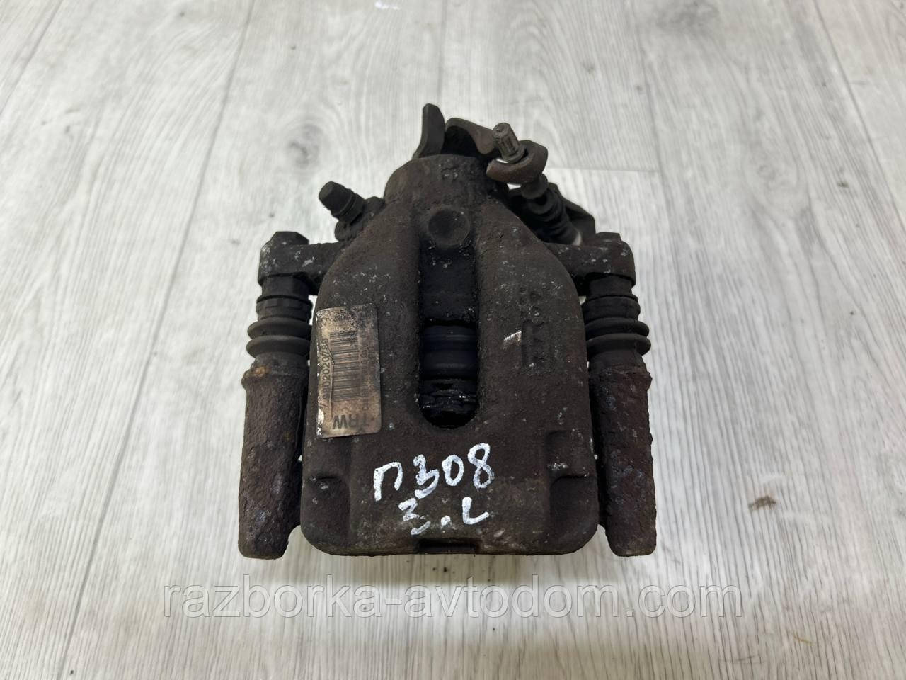 Суппорт задній лівий Peugeot 308 (07-13) OE:9802020780